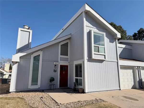 a front view of a house with a wooden fence