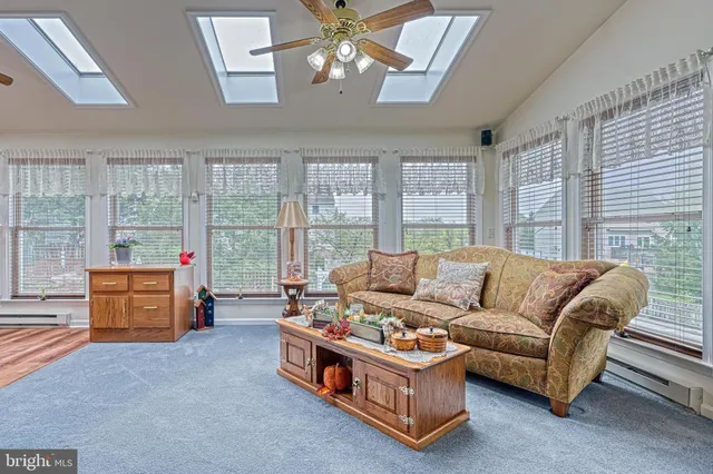a living room with furniture and large windows