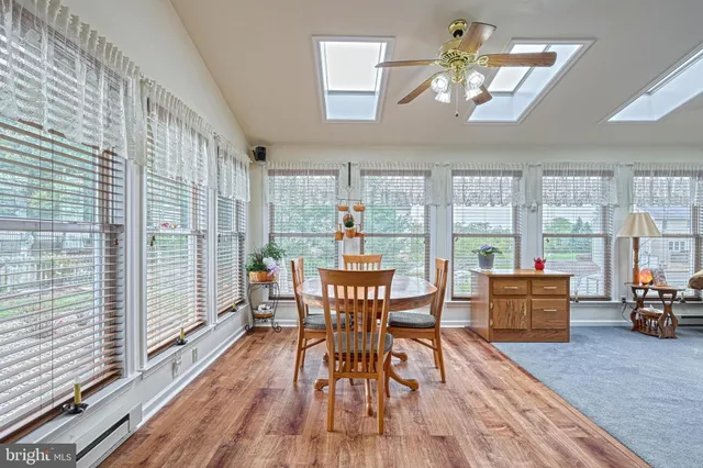a view of a dining room with furniture large windows and wooden floor