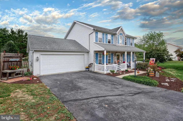a group of people sitting in front of a house