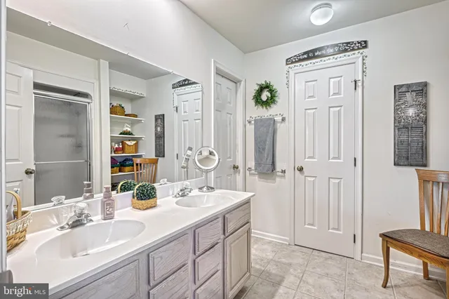 a bathroom with a double vanity sink a mirror and a