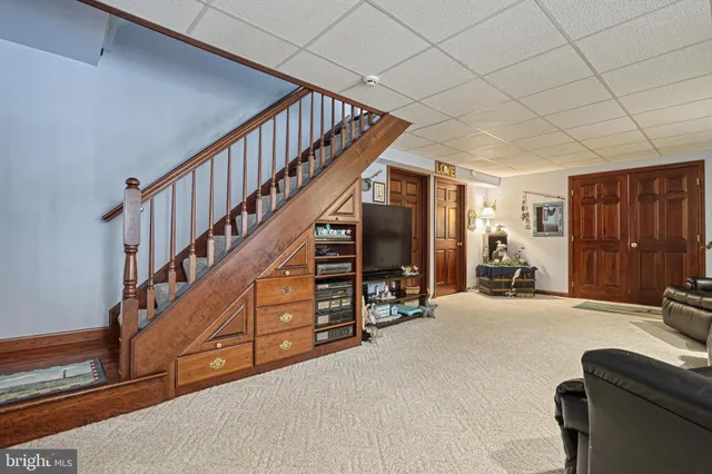 a living room with furniture a ceiling fan and a window