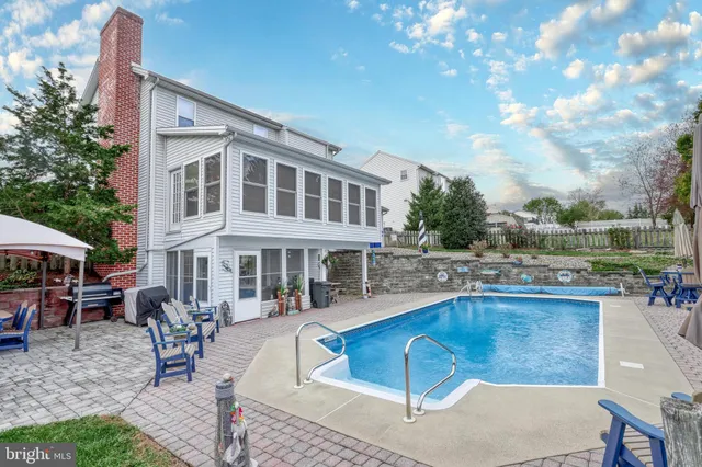 a swimming pool with outdoor seating and yard