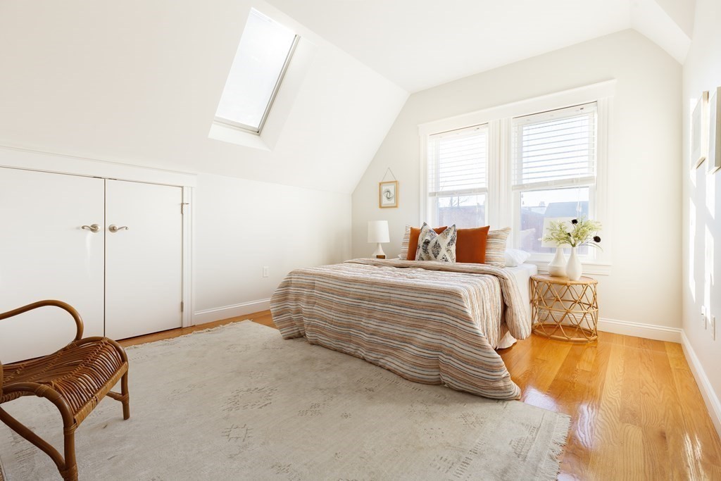 32 Cedar Street, Unit 2 Somerville, MA 02143 - Photo 14 of 20 a bedroom with a bed couch and a window