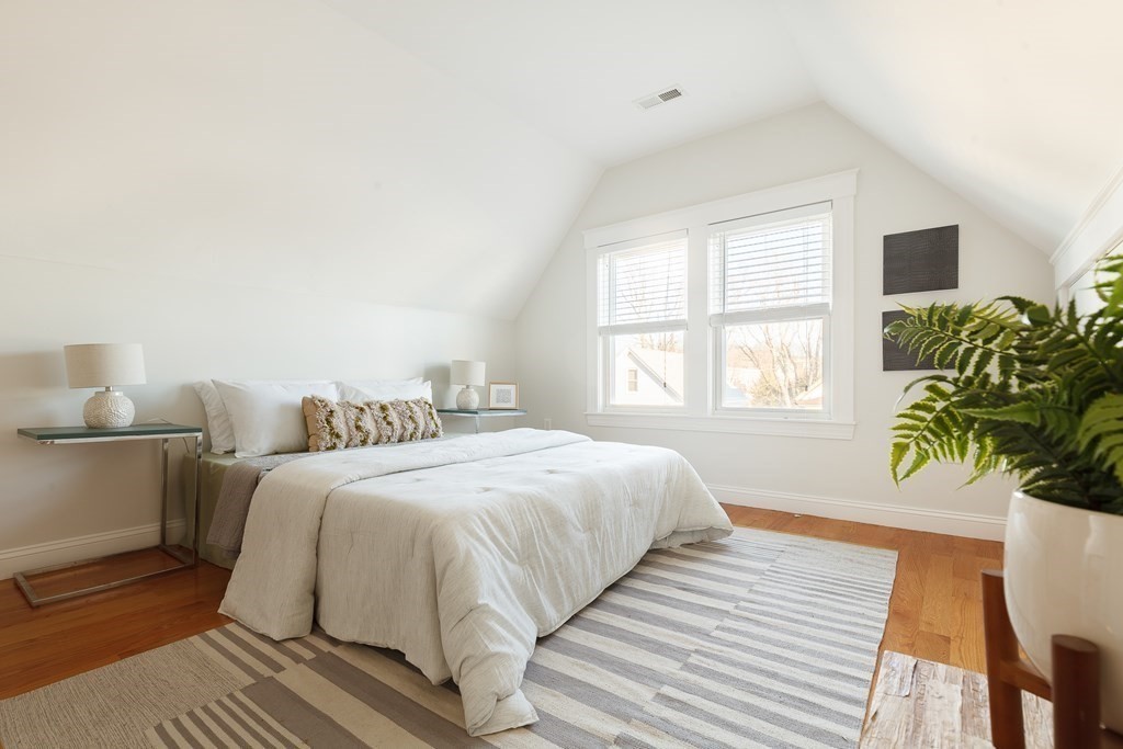 32 Cedar Street, Unit 2 Somerville, MA 02143 - Photo 16 of 20 a spacious bedroom with a bed and a potted plant