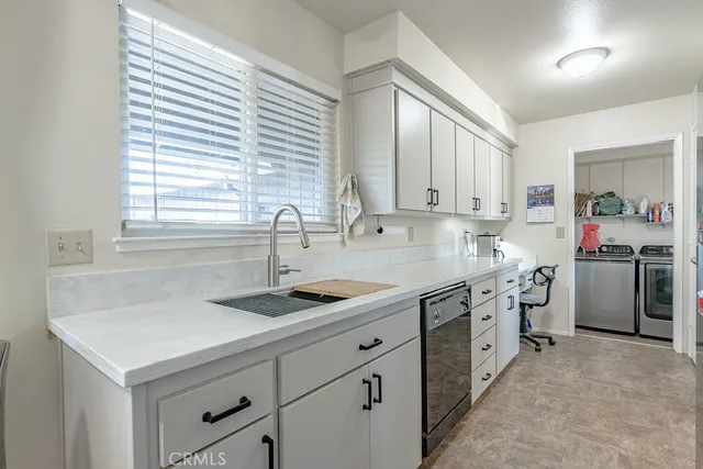 a kitchen that has a sink and a stove in it