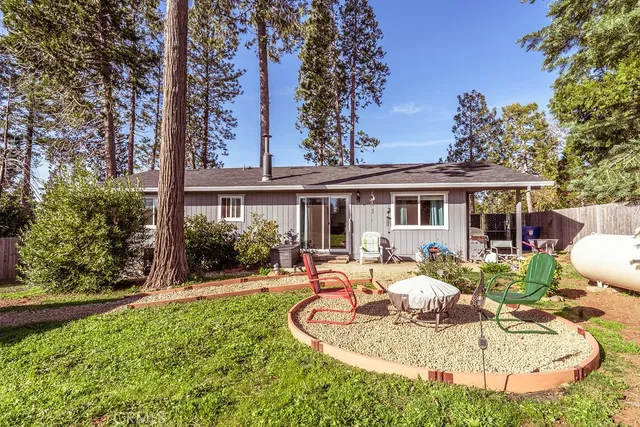 a view of a house with backyard porch and furniture