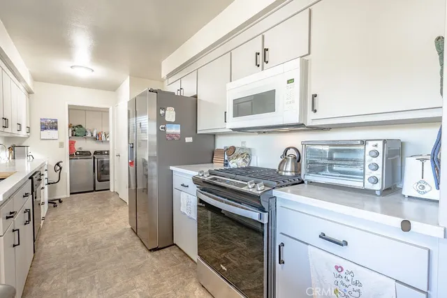 a kitchen with stainless steel appliances granite countertop a stove and a refrigerator