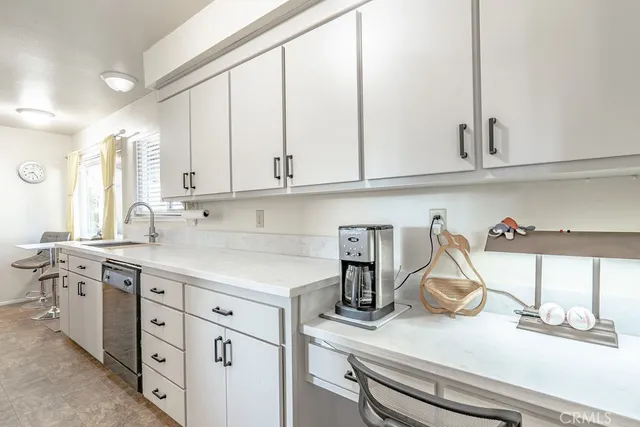 a kitchen with a sink and cabinets
