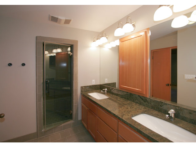 21 Martinez Road Woodside, CA 94062 - Photo 7 of 12 a bathroom with a granite countertop sink a mirror and a shower