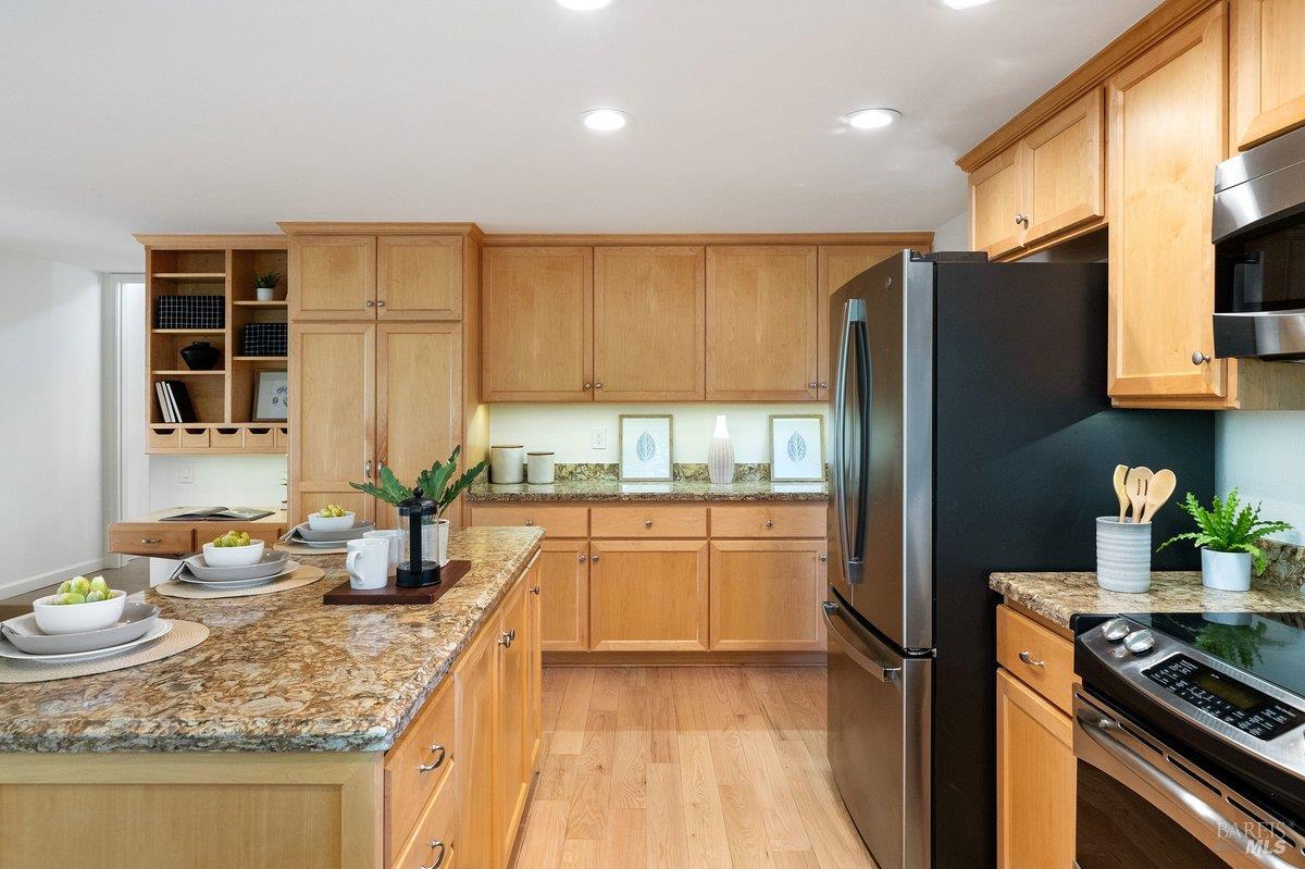 116 Twelveoak Hill Drive San Rafael, CA 94903 - Photo 33 of 93 a kitchen with granite countertop kitchen island stainless steel appliances a refrigerator a sink a stove cabinets counter space and a window
