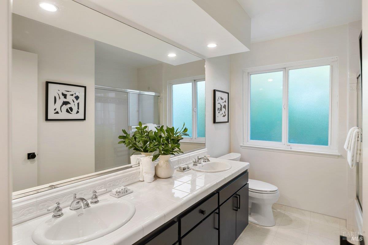 116 Twelveoak Hill Drive San Rafael, CA 94903 - Photo 68 of 93 a bathroom with a granite countertop sink a toilet and mirror