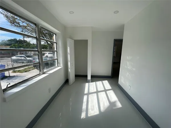a view of an empty room with a window