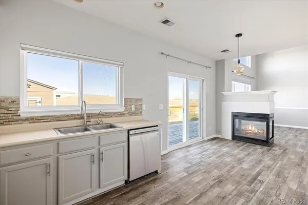 a kitchen with a sink and a fireplace