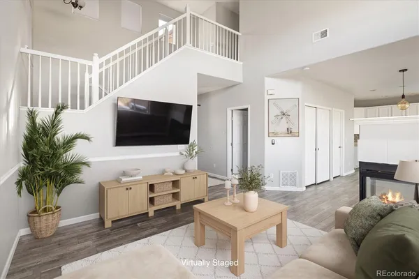 a living room with furniture potted plant and a flat screen tv