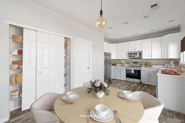 a open dining room with furniture and wooden floor
