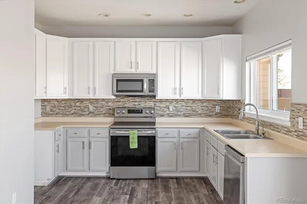 a kitchen with sink cabinets and window