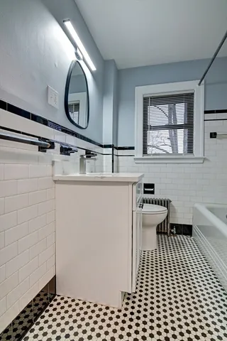 a bathroom with a sink a toilet and a mirror