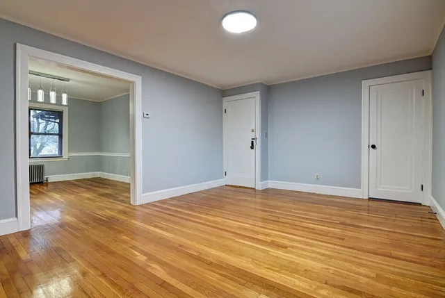 a view of an empty room and wooden floor
