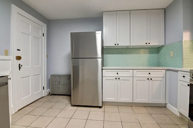 a kitchen with white cabinets