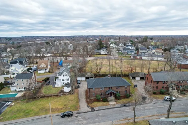 an aerial view of a houses with yard