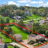 an aerial view of a house with swimming pool and garden