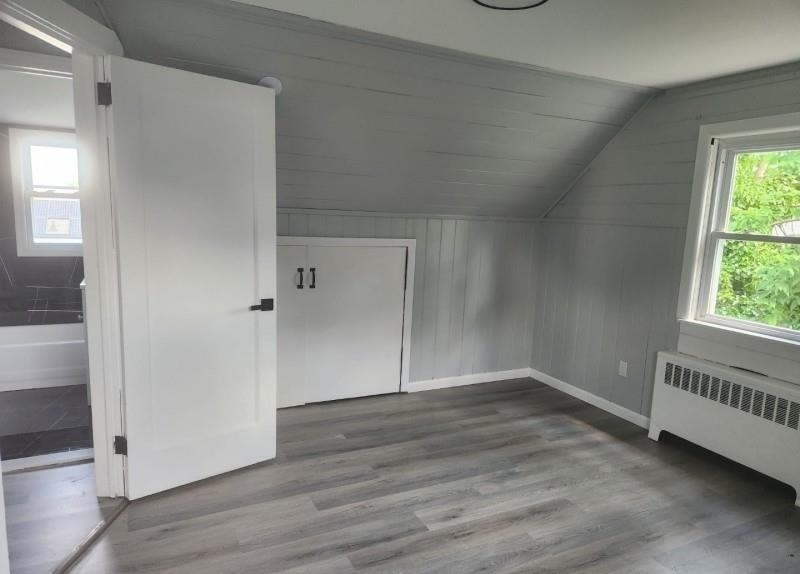 123 Prospect Street, Unit 2 Roselle, NJ 07203 - Photo 2 of 9 an empty room with wooden floor and windows