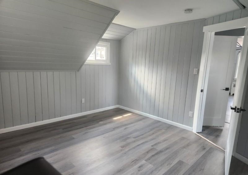 123 Prospect Street, Unit 2 Roselle, NJ 07203 - Photo 3 of 9 an empty room with wooden floor and windows