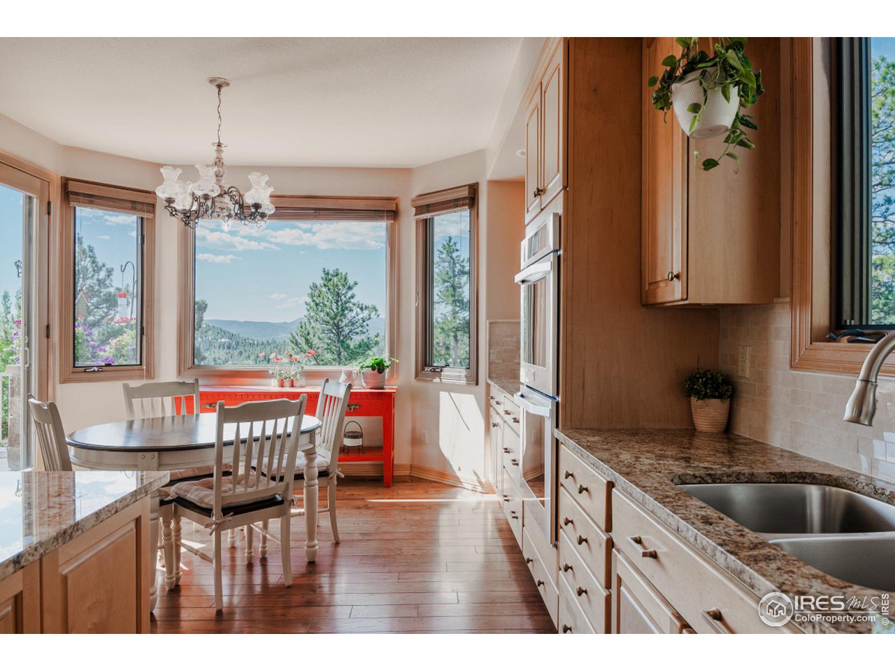 2964 Elk View Drive Evergreen, CO 80439 - Photo 11 of 40 a kitchen with a table chairs and cabinets