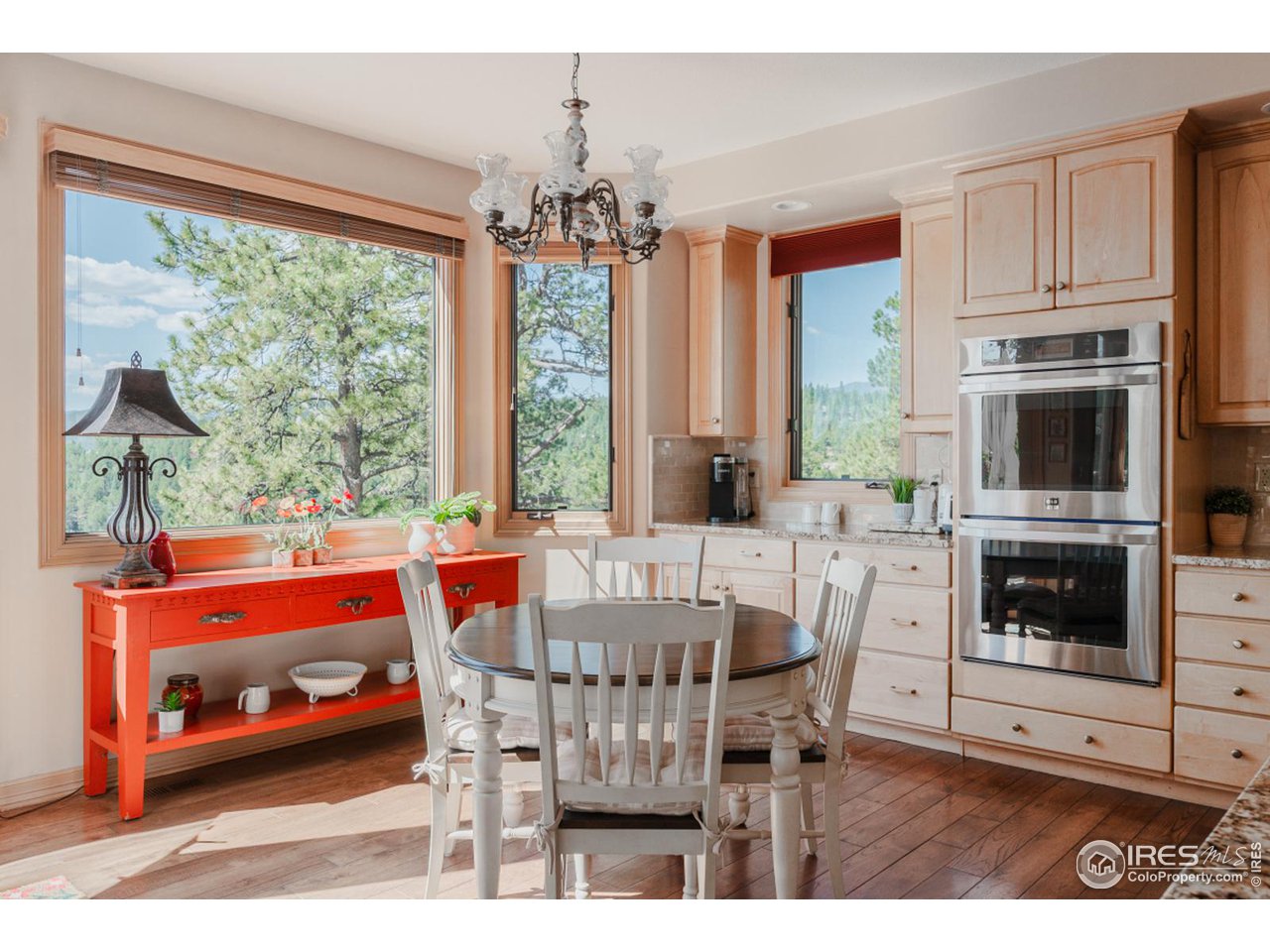 2964 Elk View Drive Evergreen, CO 80439 - Photo 13 of 40 a view of a dining room with furniture a chandelier and wooden floor