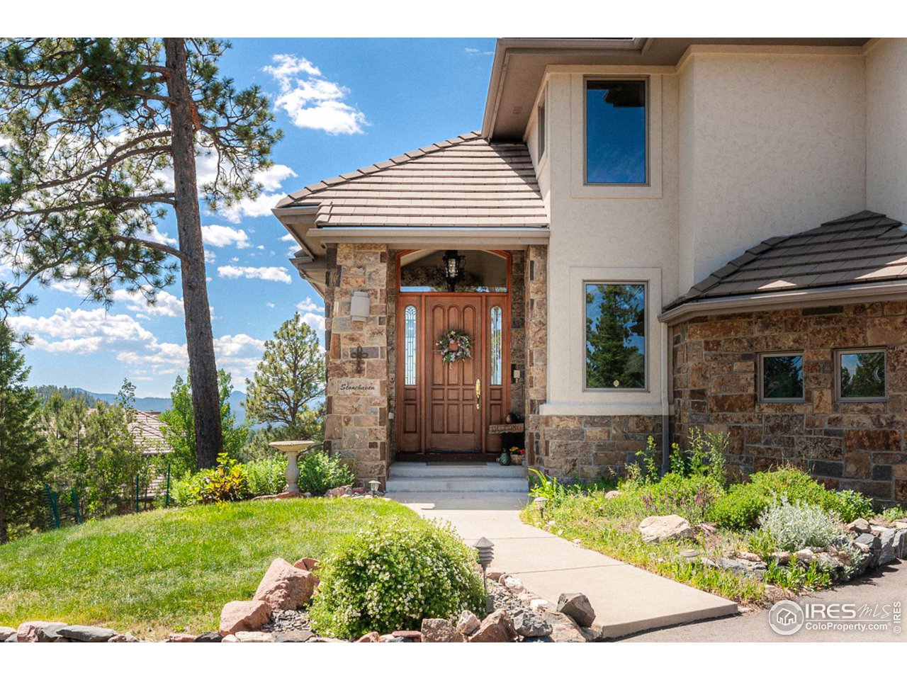 2964 Elk View Drive Evergreen, CO 80439 - Photo 4 of 40 a front view of a house with garden