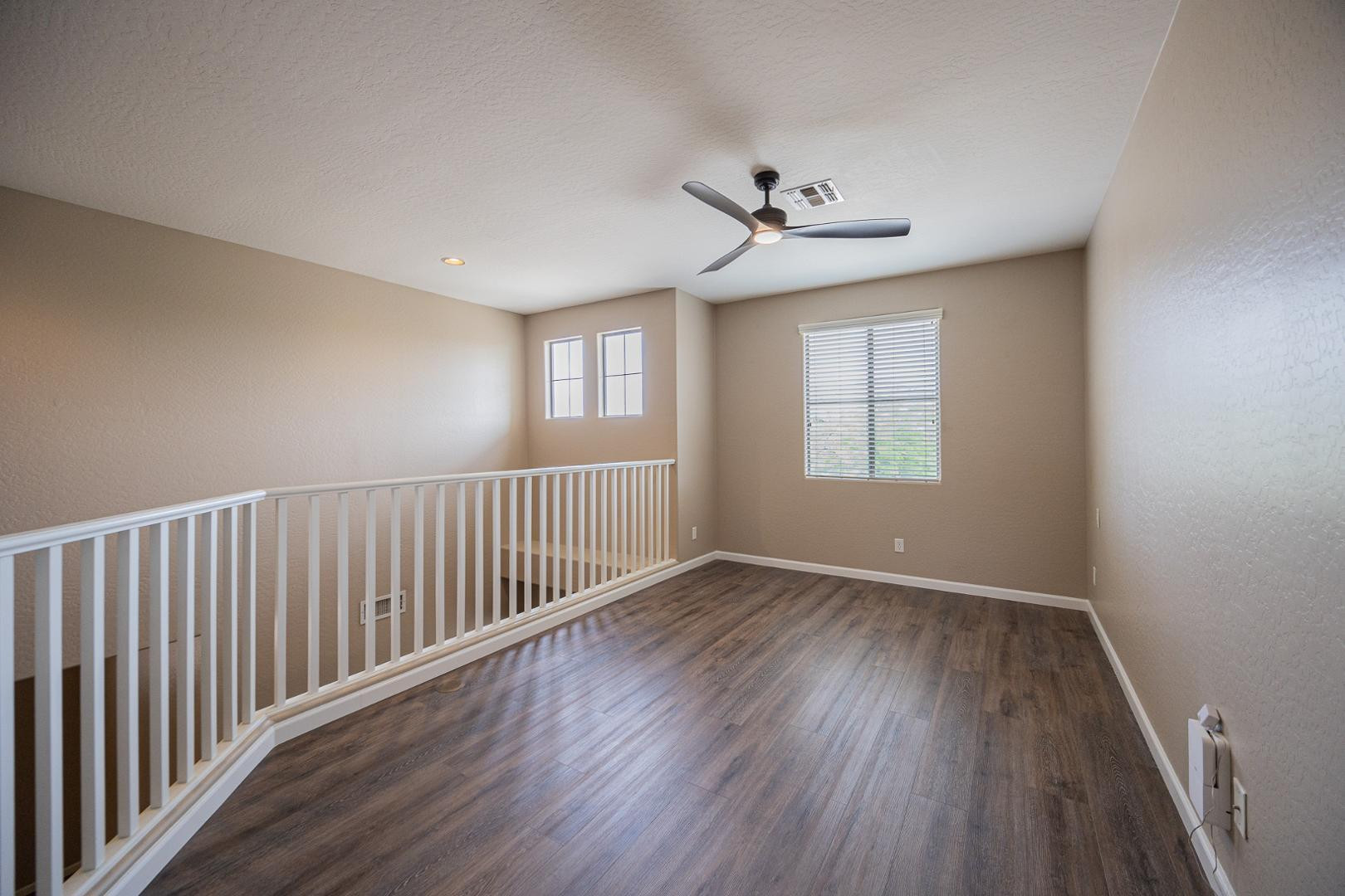 6539 West Jomax Road Phoenix, AZ 85083 - Photo 13 of 39 wooden floor in an empty room with a window
