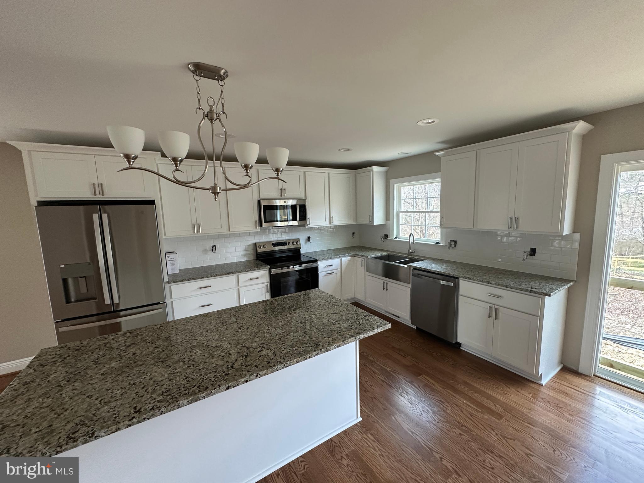 116 Pinto Winchester, VA 22602 - Photo 8 of 23 a large kitchen with a center island wooden floor stainless steel appliances and cabinets