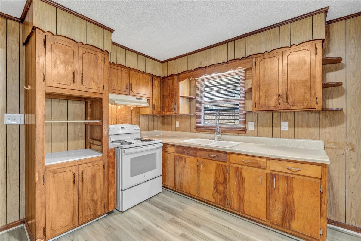 390 Junus Jackson Hollow Road Minor Hill, TN 38473 - Photo 14 of 38 a kitchen with stainless steel appliances granite countertop a sink and cabinets
