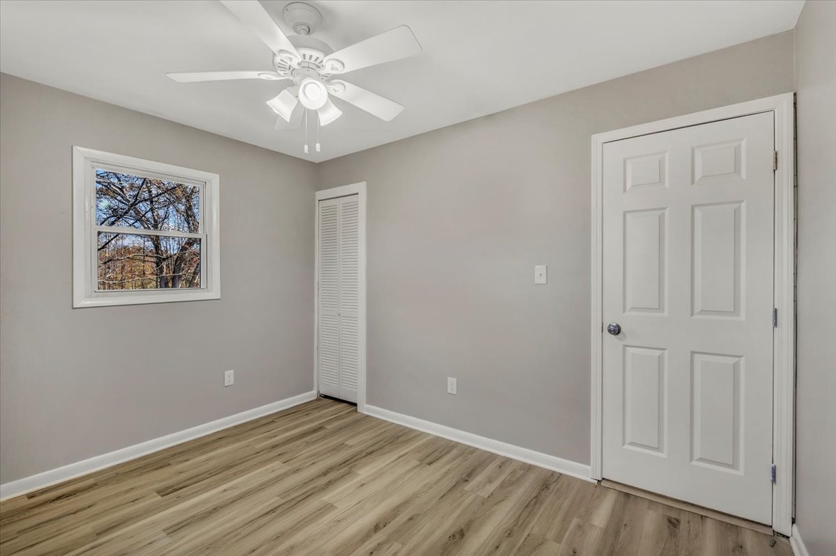 390 Junus Jackson Hollow Road Minor Hill, TN 38473 - Photo 19 of 38 wooden floor in an empty room with a window