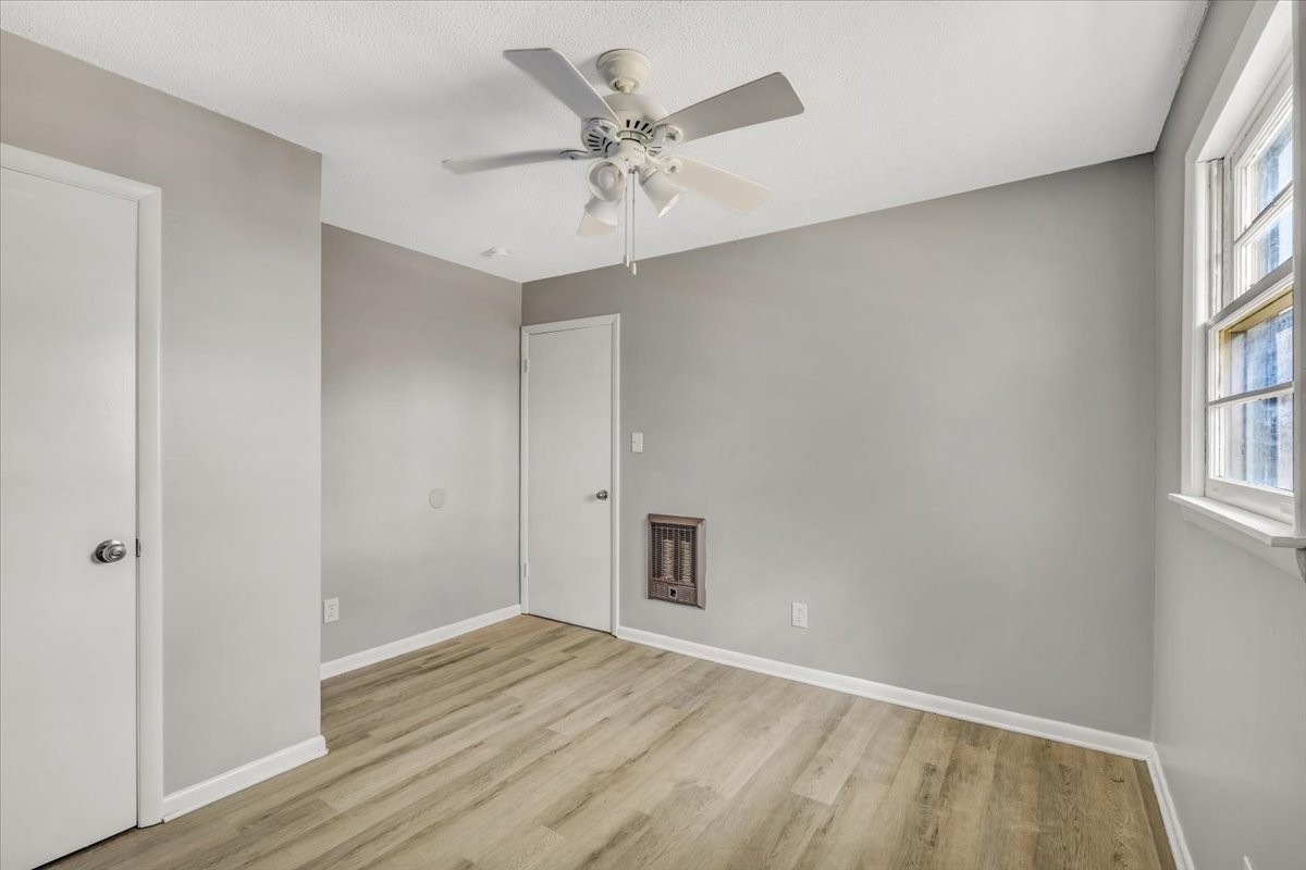 390 Junus Jackson Hollow Road Minor Hill, TN 38473 - Photo 23 of 38 wooden floor in an empty room with a window
