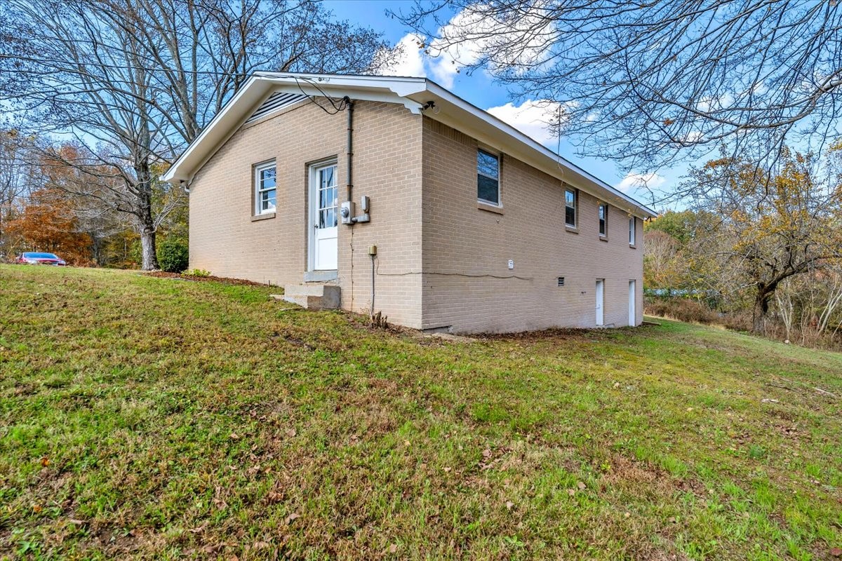 390 Junus Jackson Hollow Road Minor Hill, TN 38473 - Photo 6 of 38 a view of backyard of house with wooden fence
