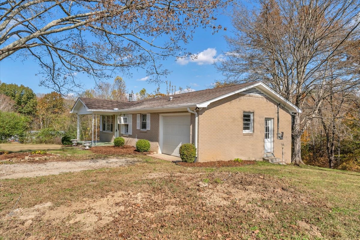 390 Junus Jackson Hollow Road Minor Hill, TN 38473 - Photo 10 of 38 a view of a house with backyard and sitting area