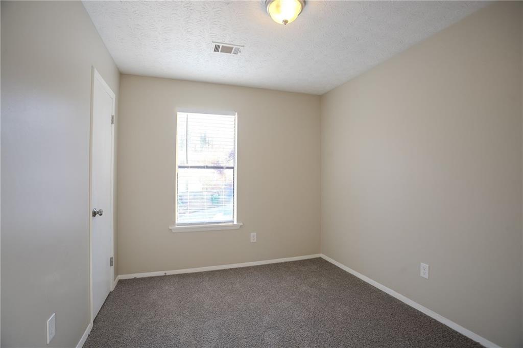 5449 Martins Crossing Road Stone Mountain, GA 30088 - Photo 12 of 32 an empty room with a window