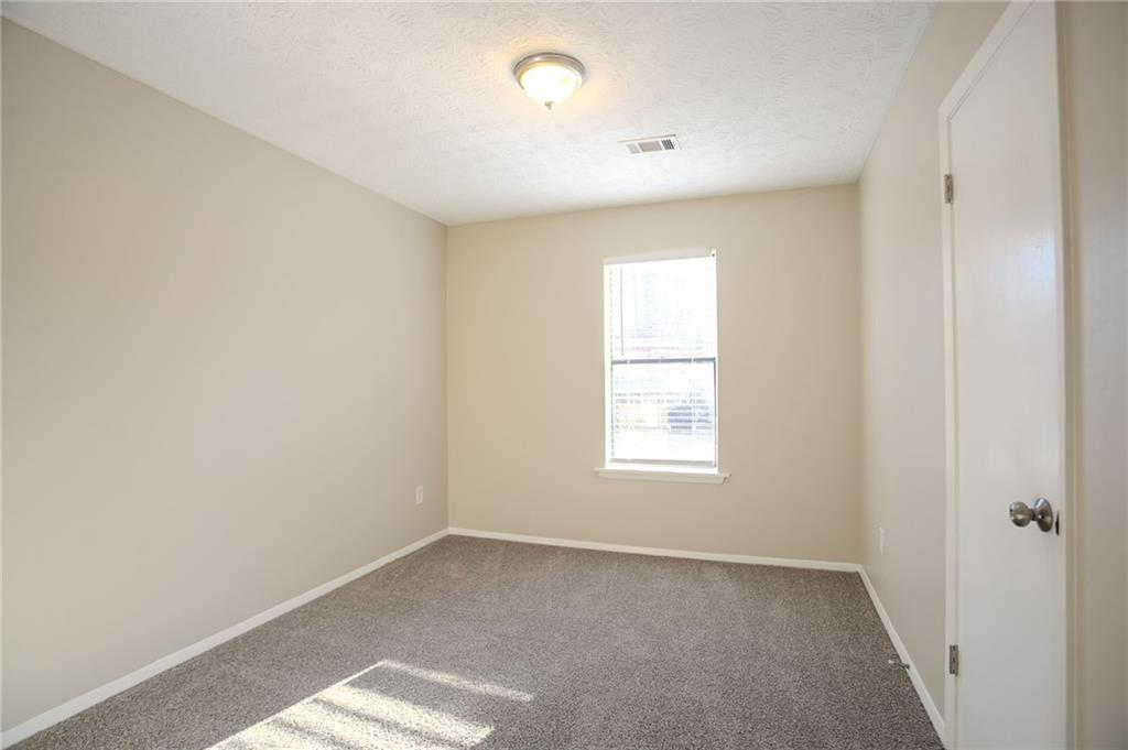 5449 Martins Crossing Road Stone Mountain, GA 30088 - Photo 14 of 32 an empty room with windows