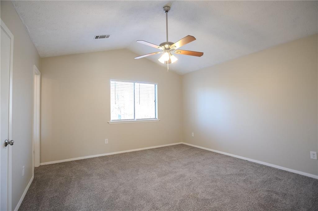 5449 Martins Crossing Road Stone Mountain, GA 30088 - Photo 17 of 32 an empty room with windows and fan