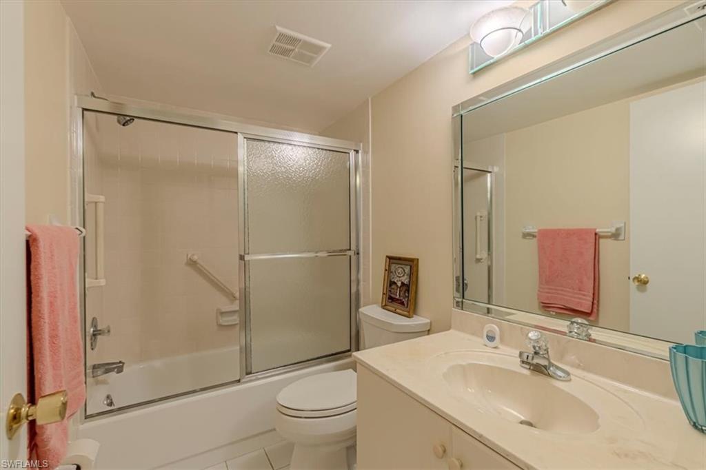 5483 Rattlesnake Hammock Road, Unit B201 Naples, FL 34113 - Photo 17 of 22 a bathroom with a sink toilet and shower