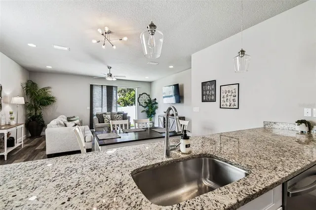 a kitchen with a granite countertop living room