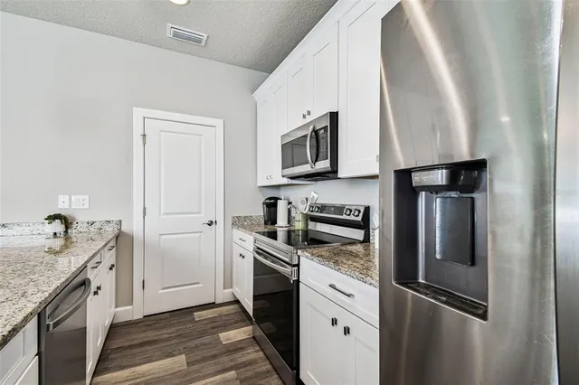 a kitchen with a refrigerator stove and sink