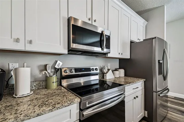 a kitchen with a refrigerator stove and microwave