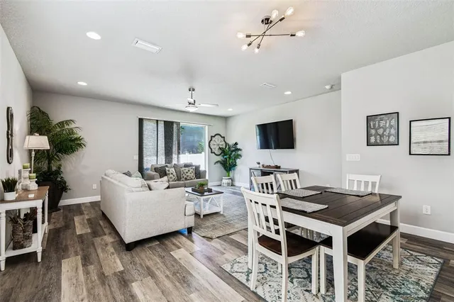 a living room with furniture a flat screen tv and a table