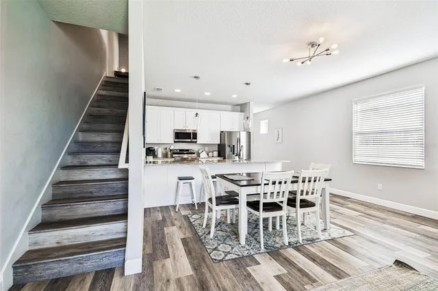 a view of a dining room with furniture and wooden floor