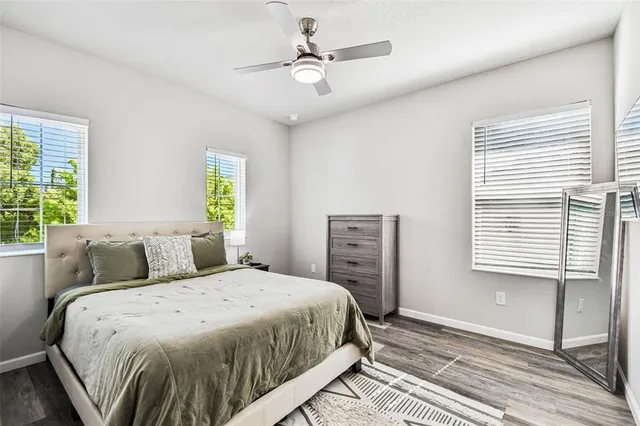 a bedroom with a bed next to a window and a chandelier