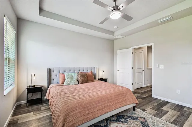 a bedroom with a bed and a chandelier