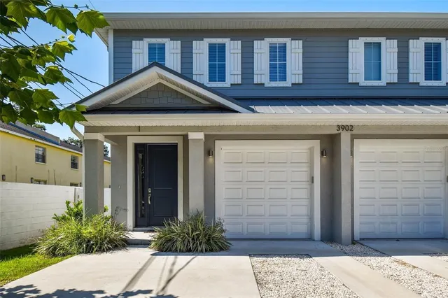 a view of a house with potted plants